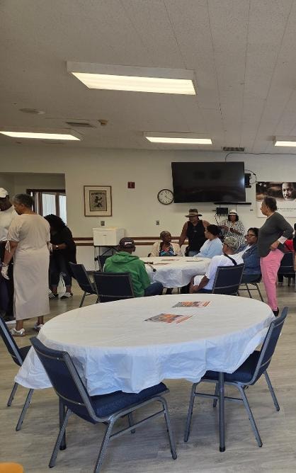Church family seated and mingling in the fellowship hall at the Church BBQ 2026 — MLK Memorial Baptist Church