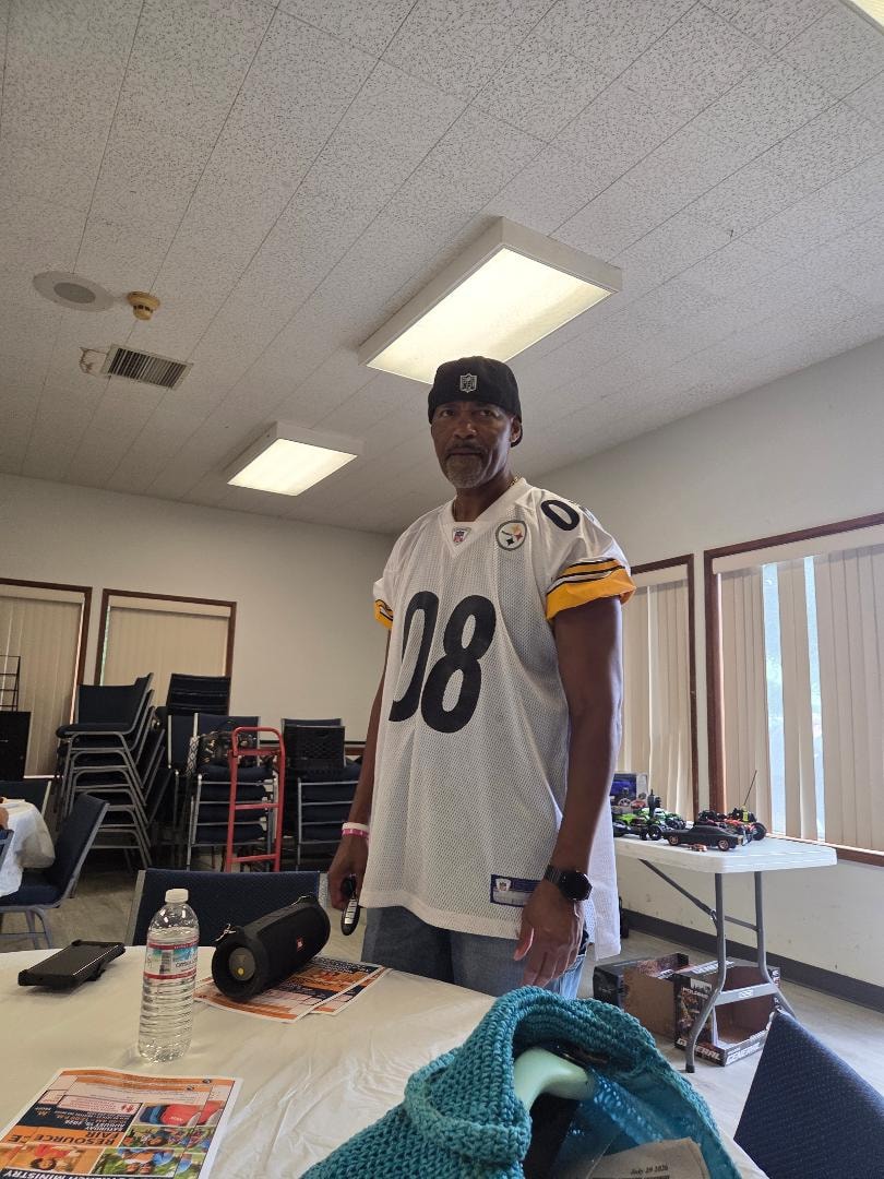 Donald in a Steelers jersey standing in the fellowship hall at the Church BBQ 2026 — MLK Memorial Baptist Church