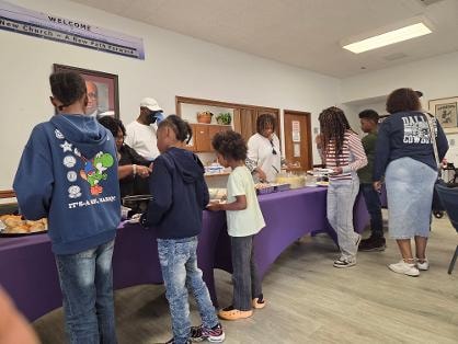 Church family serving up plates along the full buffet table at the BBQ 2026 — MLK Memorial Baptist Church