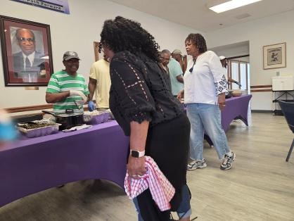 Jeanette and church members at the buffet table during the Church BBQ 2026 — MLK Memorial Baptist Church