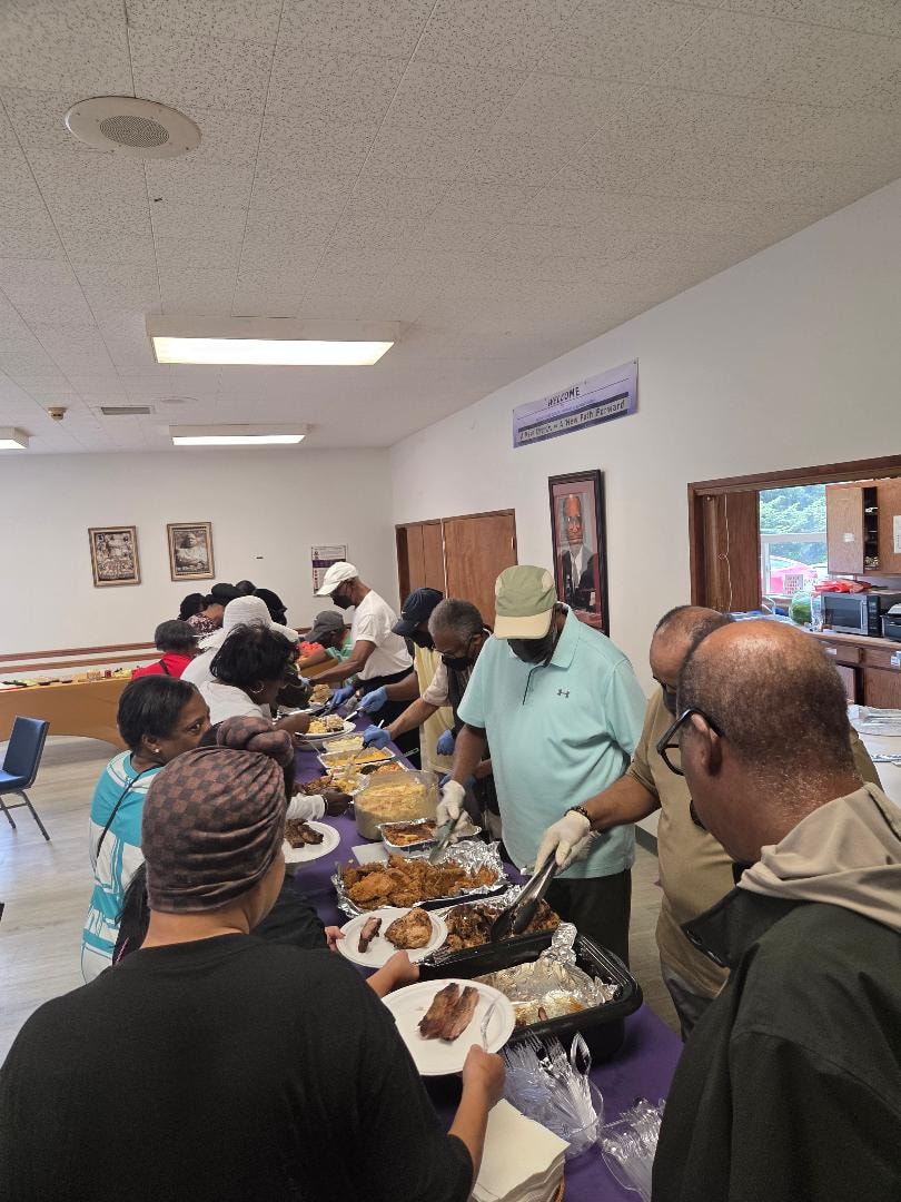 Volunteers serving fried chicken and sides along the full buffet line at the Church BBQ 2026 — MLK Memorial Baptist Church