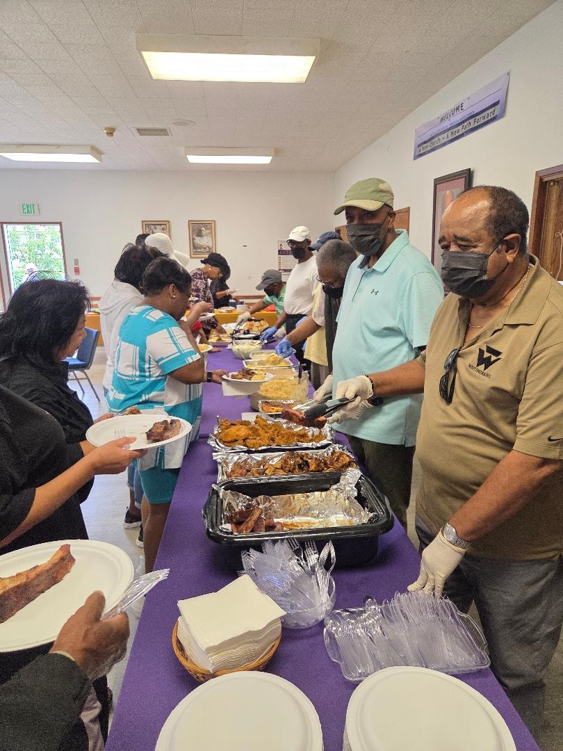 Sherry and volunteers serving the congregation at the BBQ buffet line — MLK Memorial Baptist Church 2026