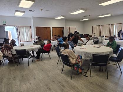 Church family seated at round tables waiting to enjoy the BBQ meal — MLK Memorial Baptist Church 2026
