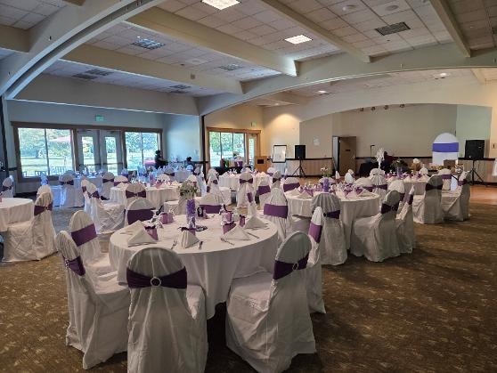 Elegant ballroom with round tables dressed in white linens and purple chair sashes at the Golden Jubilee All-White Affair — MLK Memorial Baptist Church 2026