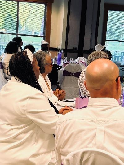 Church members dressed in white seated at elegantly decorated tables at the Golden Jubilee All-White Affair — MLK Memorial Baptist Church 2026