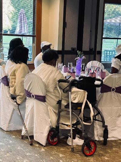 Guests seated at beautifully decorated tables near large windows at the Golden Jubilee All-White Affair — MLK Memorial Baptist Church 2026