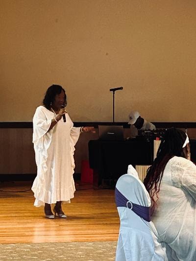 Woman in white dress on stage at the Golden Jubilee All-White Affair — MLK Memorial Baptist Church 2026