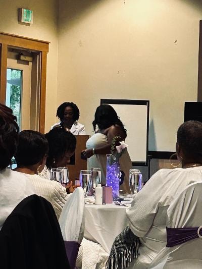 Guests in white attire gathered near the podium at the Golden Jubilee All-White Affair — MLK Memorial Baptist Church 2026