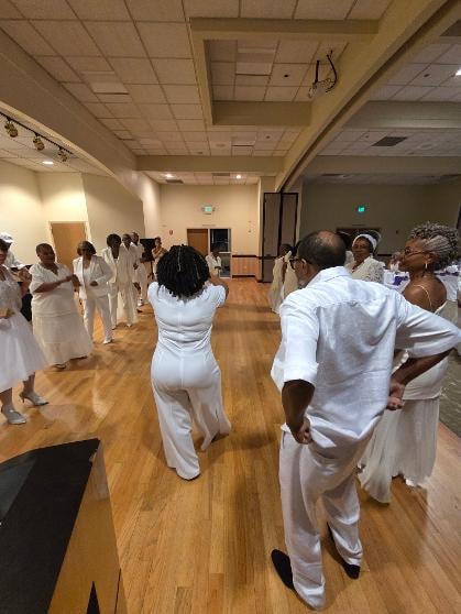 Guests in white attire on the dance floor at the Golden Jubilee All-White Affair 2026