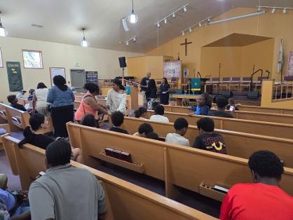 Two people at the front of the sanctuary — VBS Day 1