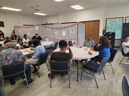 Fellowship dinner — children and adults at tables VBS Day 1