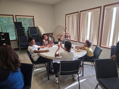 Fellowship dinner — ladies gathered at table VBS Day 1