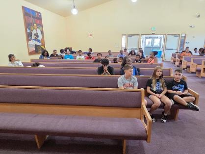 Children in sanctuary pews — Day 1