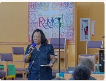 VBS teacher speaking at the front of the sanctuary — Day 1