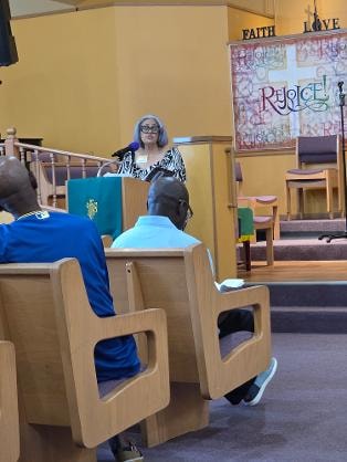 VBS teacher at the podium — Day 1