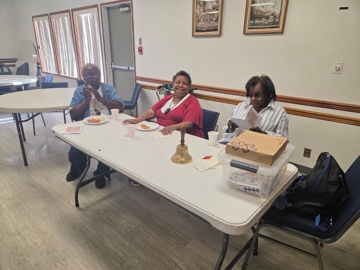 Three members seated at table — VBS Day 2