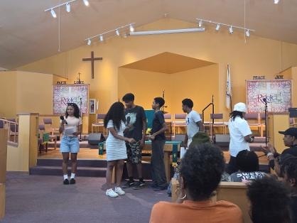 Youth presenting at the altar during VBS Day 3 Assembly — MLK Memorial Baptist Church