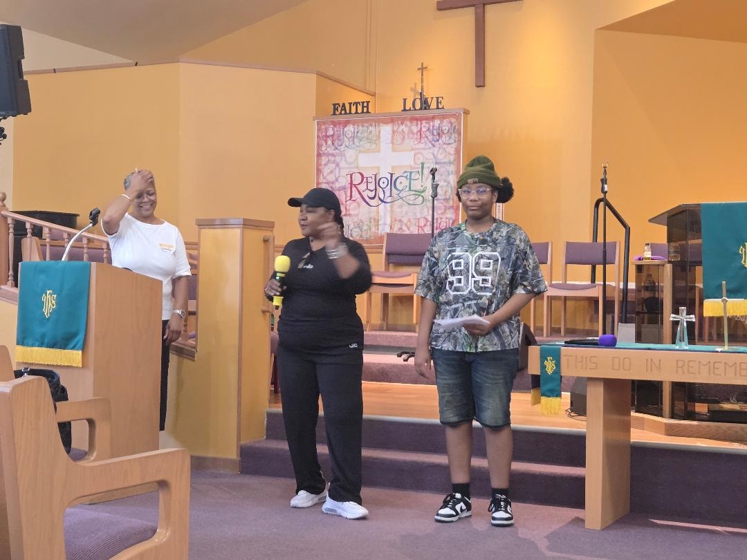 Adult and youth presenting at the sanctuary — VBS Day 3 Assembly