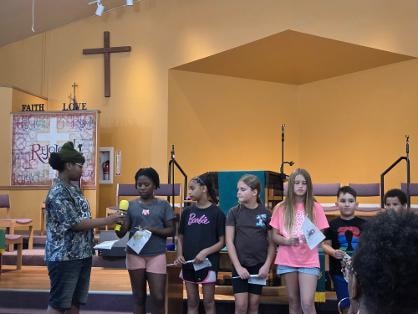 Youth group presenting at the sanctuary — VBS Day 3 Assembly