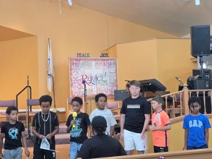 Children on stage at the sanctuary during VBS Day 3 Assembly — MLK Memorial Baptist Church