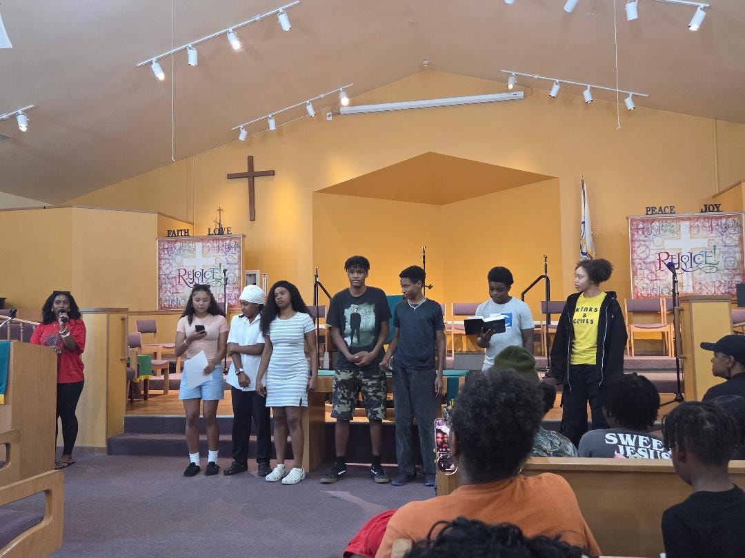 Youth group presenting with microphones on stage — VBS Day 3 Assembly, MLK Memorial Baptist Church