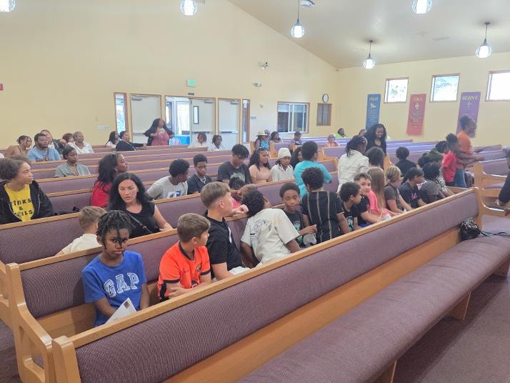 Children and adults filling the pews during VBS Day 3 Assembly — MLK Memorial Baptist Church