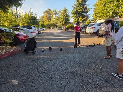 Children playing with toy cars in parking lot — VBS Day 3 Assembly