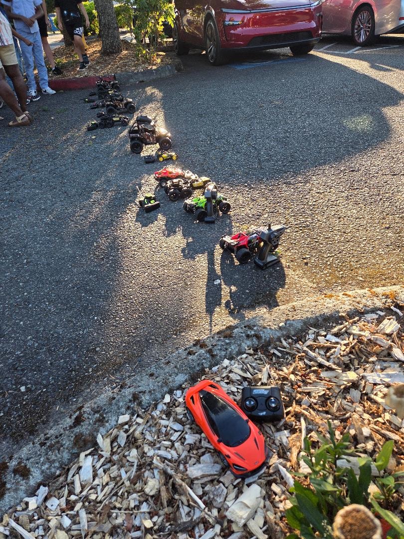 RC cars lined up in church parking lot — VBS Day 3 Assembly
