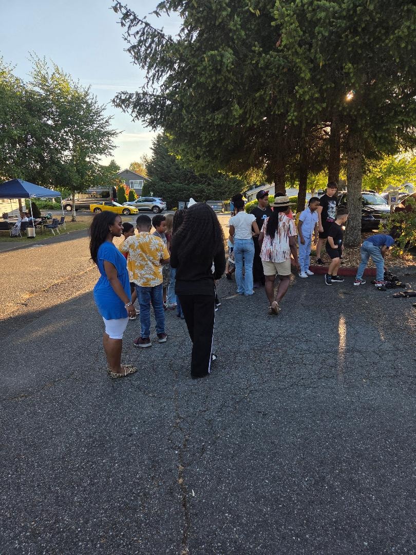 Children and adults gathered in church parking lot — VBS Day 3 Assembly
