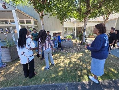 Children and adults gathered in courtyard near building — VBS Day 3 Assembly