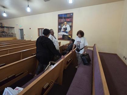 Leslie, Evelyn, and Tee in the sanctuary — VBS 2026 MLK Memorial Baptist Church