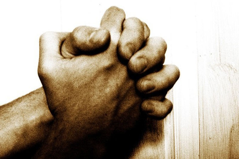 Clasped hands representing unity and prayer